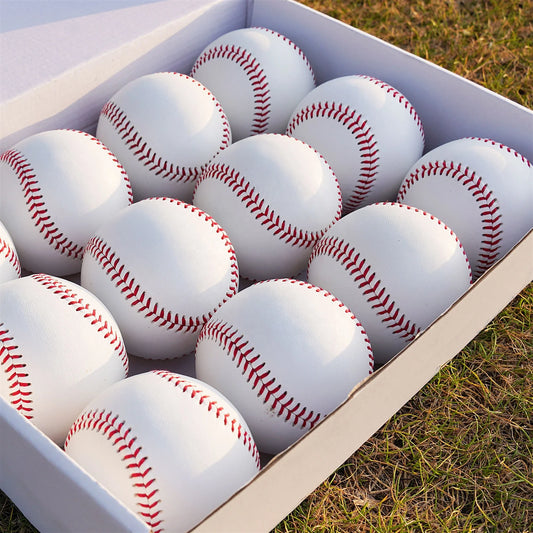 Set of white baseballs with red laced seams in a display box