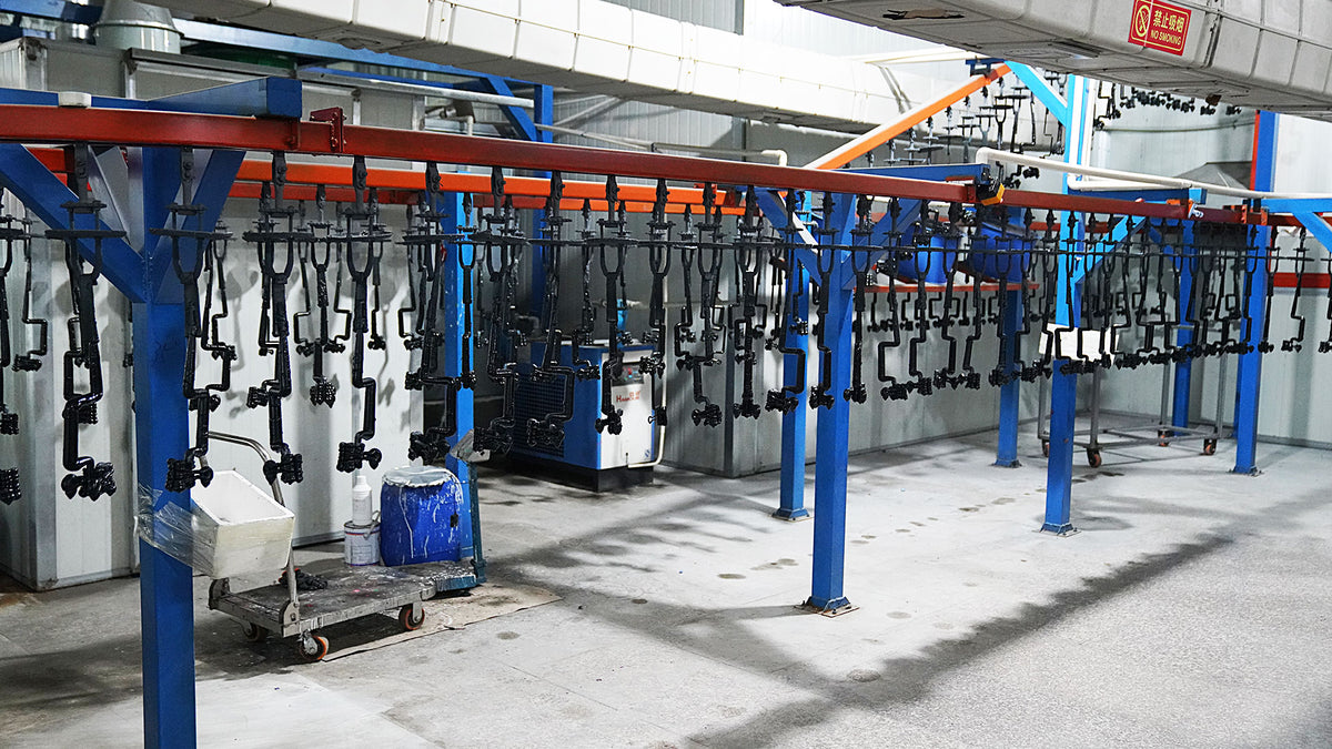 Production line display of multiple baseball bats hanging on racks