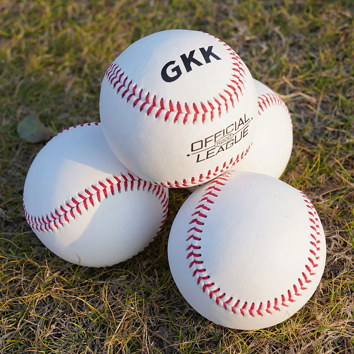 White baseballs with red laced seams, one shows GKK Official League text