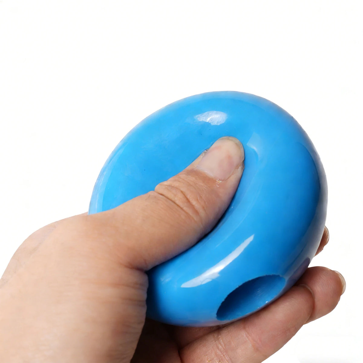Blue PVC training ball held in hand, with side grip hole