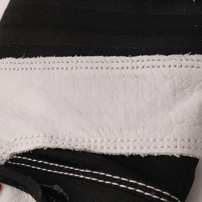 White batting glove cuff with textured black elastic and double-row stitching
