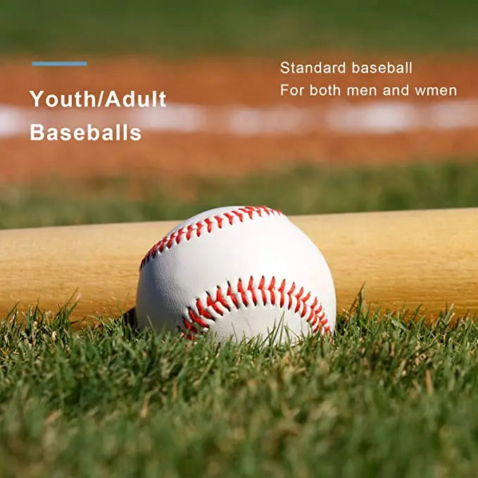 White baseball with red stitching resting on outdoor grass