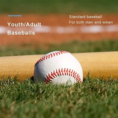 White baseball with red stitching resting on outdoor grass
